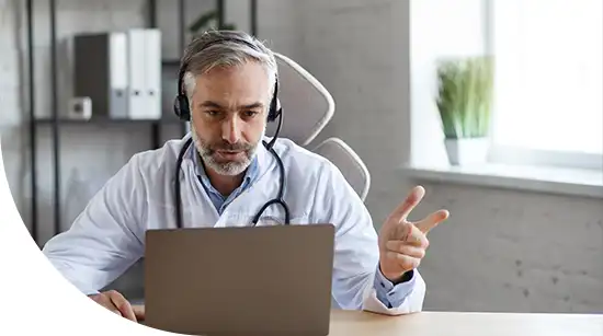 Doctor providing telehealth consultation using a laptop