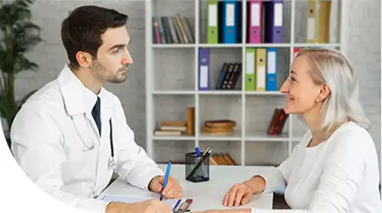 Dr listening to an elderly patient during consultation