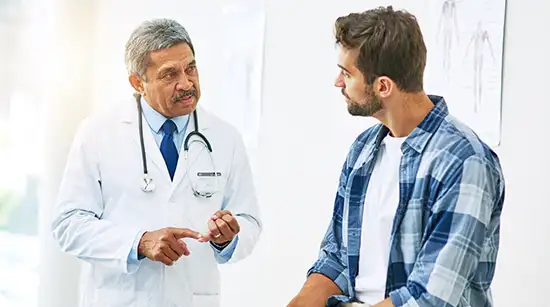 Doctor discussing diagnosis and care plan with an adult patient during a clinic visit in Trenton and Pennington, New Jersey.