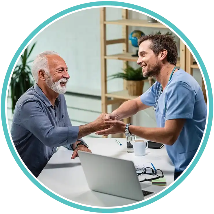 Doctor shaking hands with an elderly patient in a consultation room
