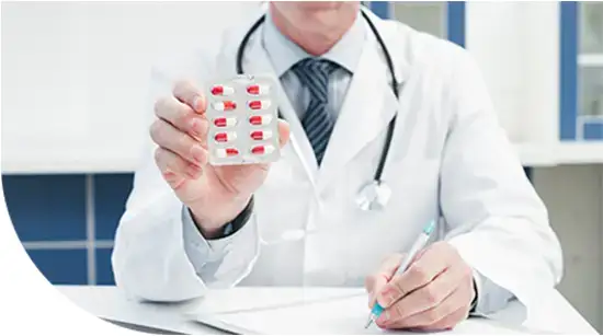 Doctor showing prescribed tablets during consultation