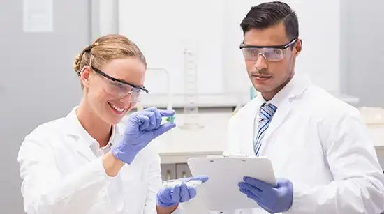 Female and male primary care doctors performing a diagnostic medical test together in their clinic.
