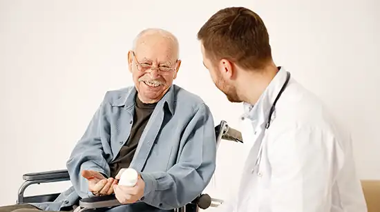 Doctor providing compassionate support to an elderly patient during recovery care