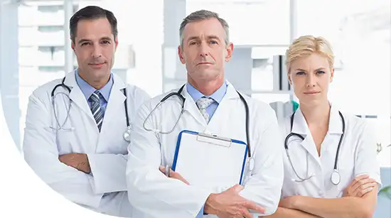 Team of experienced doctors standing together in a clinic