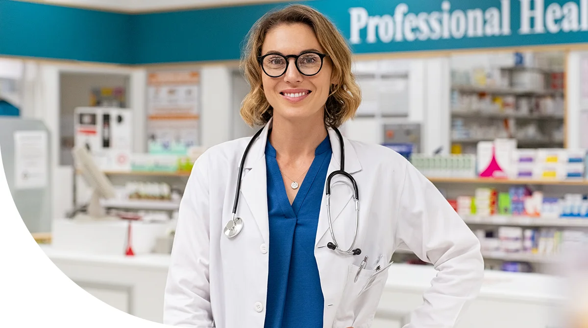 Female doctor wearing a white coat and stethoscope standing confidently in a medical clinic