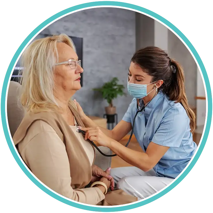 Nurse checking an elderly patient’s chest with a stethoscope