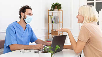 Doctor conducting a person to person medical appointment with a patient