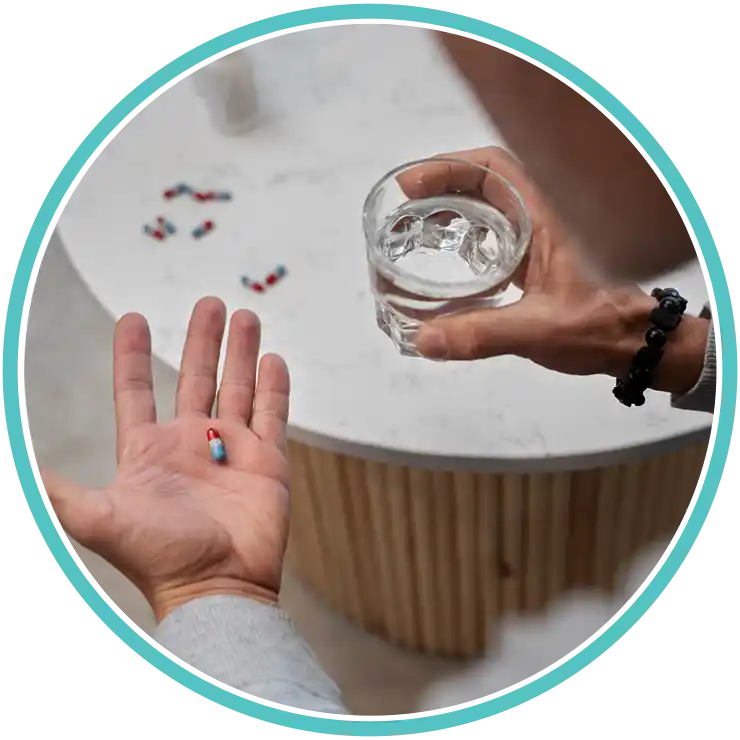 Patient holding a single MOUD pill and a glass of water, starting daily treatment.