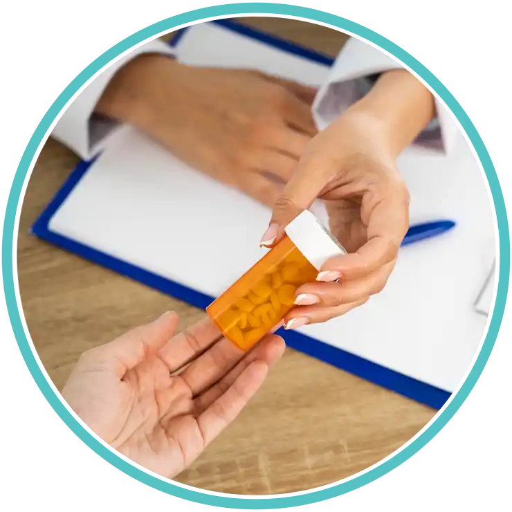A medical professional handing a prescription bottle to a patient for medication management